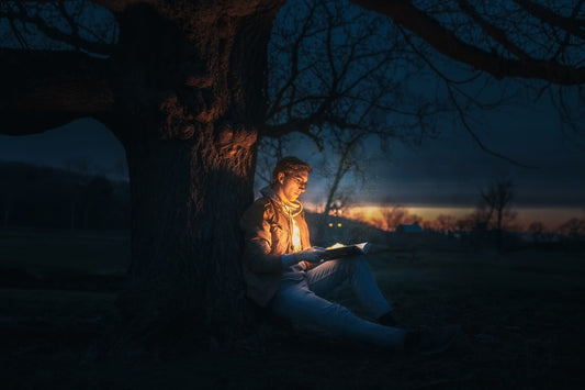 Mysterious dark book with reading lamp on a night table